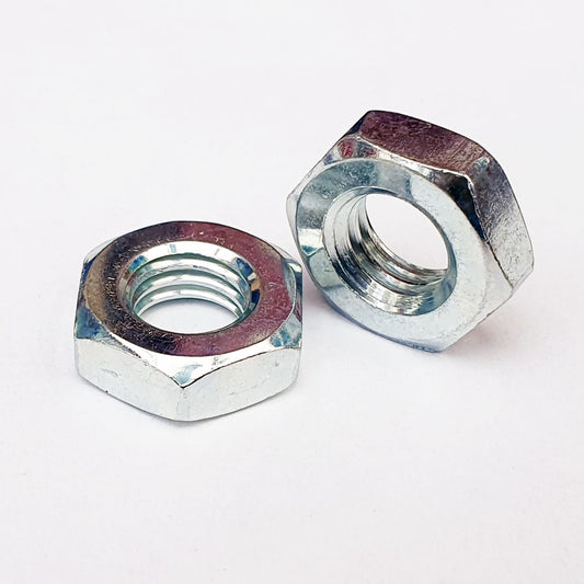 Two thin hex nuts made of white metal, one nut is facing up and the other is facing down, both with visible threaded interior. M5 Thin Hex Nut Type 3 Trivalent White Cr-3 8mm A/F JIS 312B0500